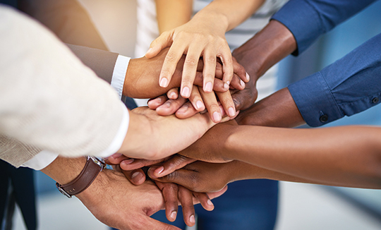 stacked hands representing teamwork